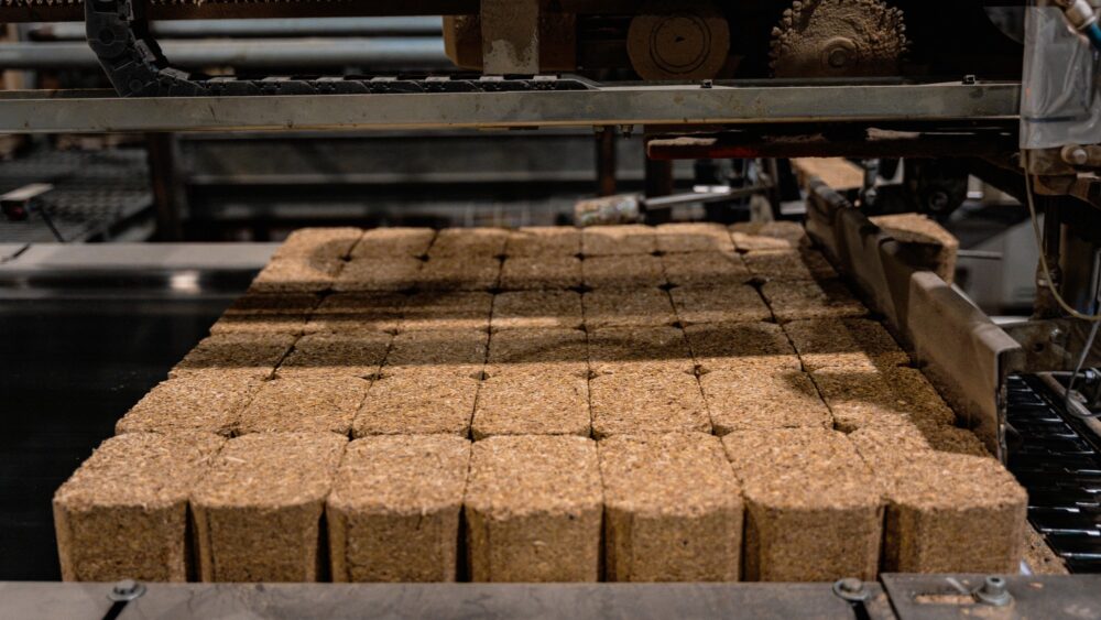 Rows of freshly extruded composite blocks on the press line.